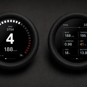 Dual round car gauges on a dark surface: left shows 3754 RPM and 188 km/h in 4th gear; right shows engine data (MAP 188 kPa, Target 195 kPa, Lambda 0.98, IAT 41°C, TPS 18%, Battery 13.8 V).